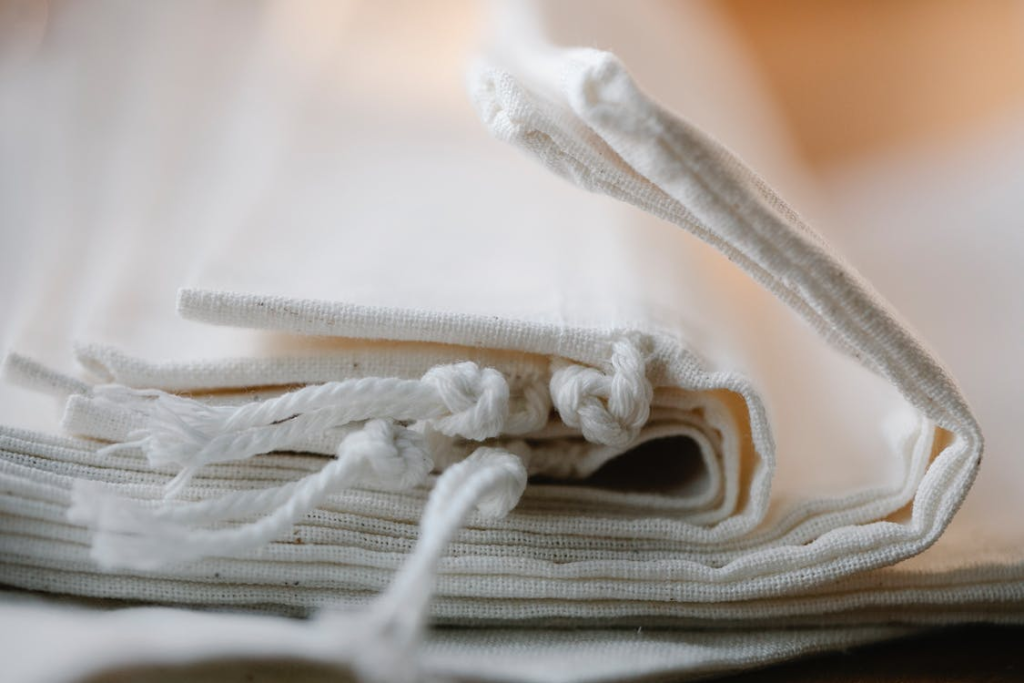 a pile of cotton tote bags